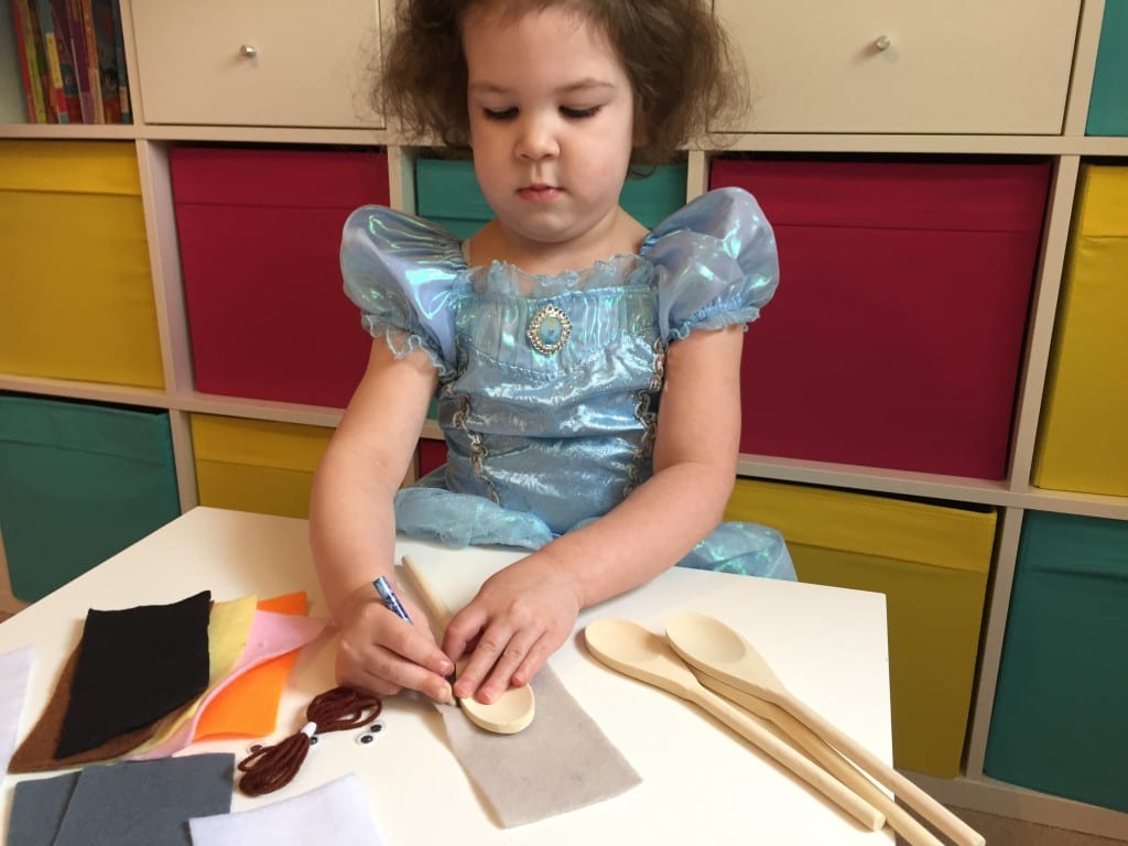 Isla drawing around her wooden spoon