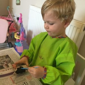 Oliver painting his toilet roll bat