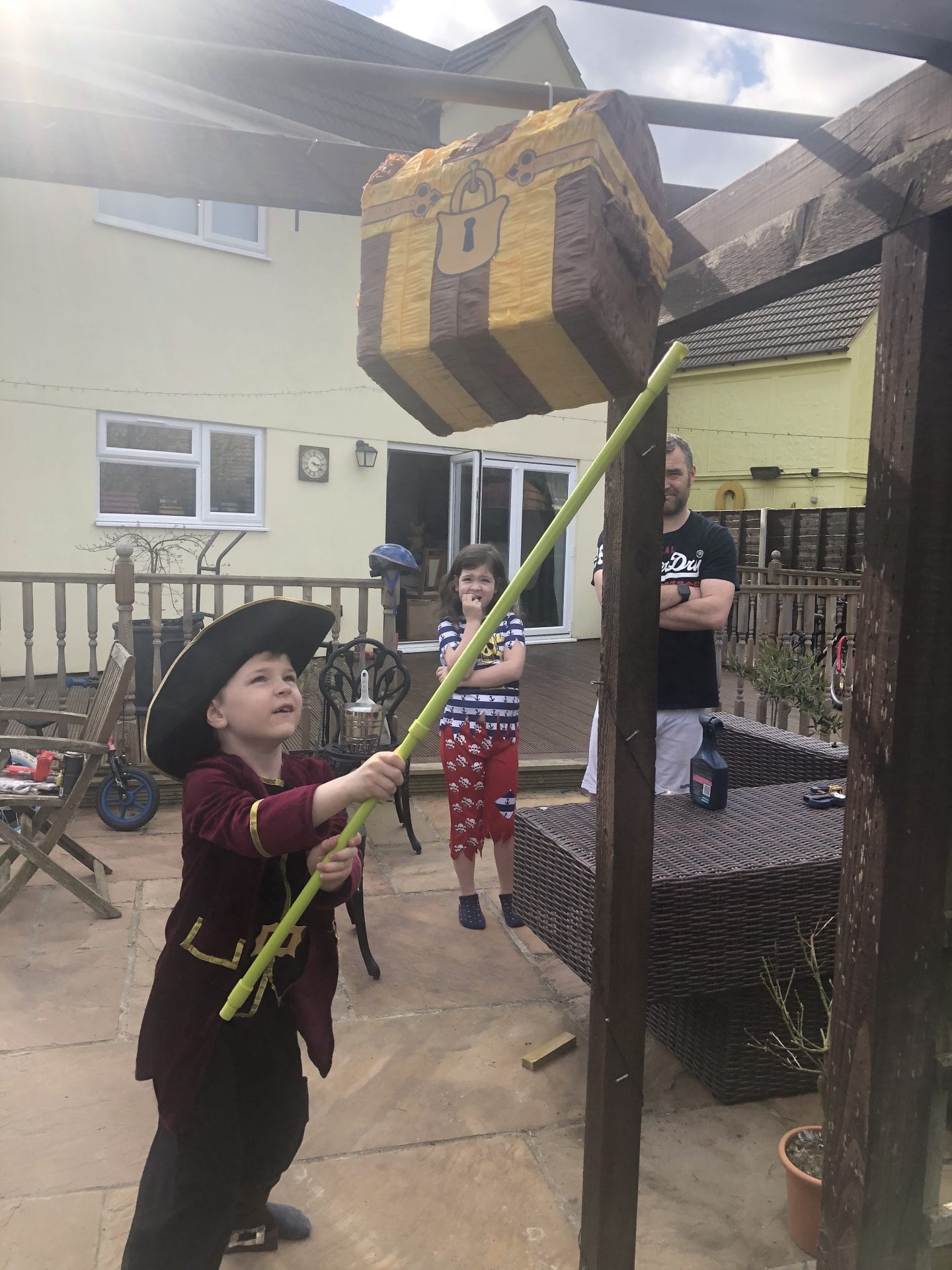 Oliver hitting a treasure chest pinnata with a green stick