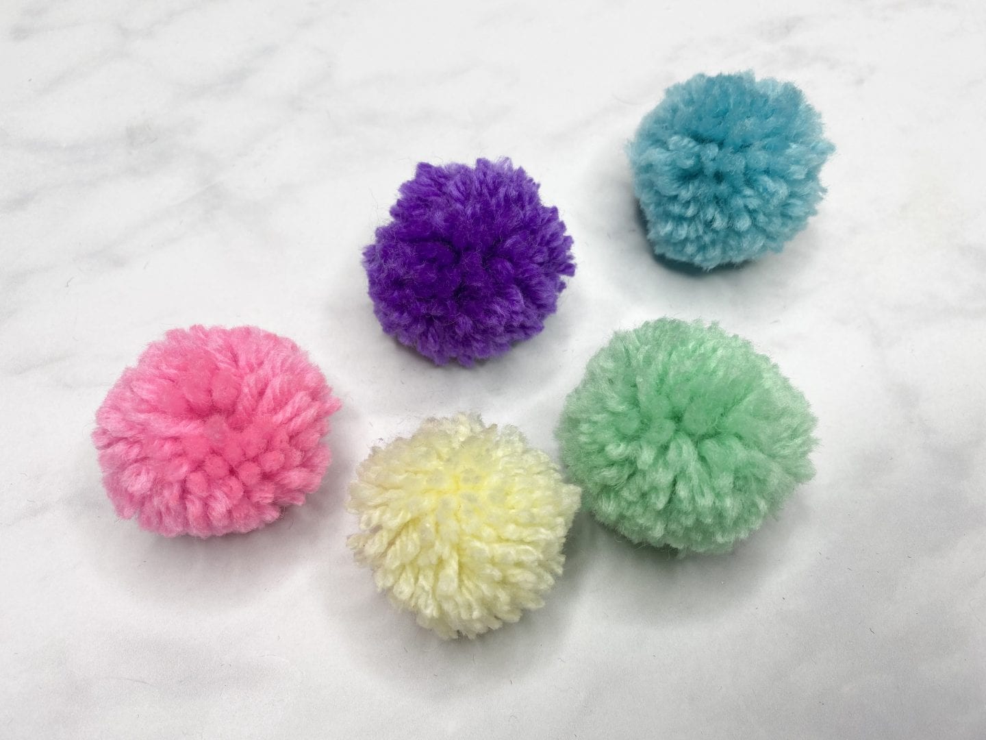 different coloured pom poms