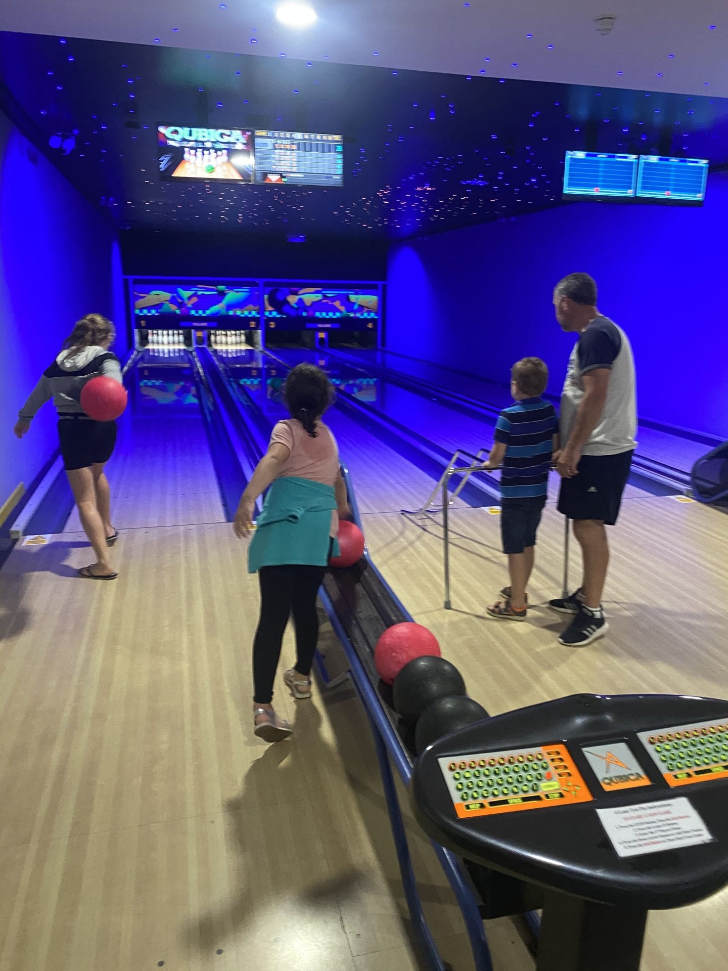 A family playing ten pin bowling