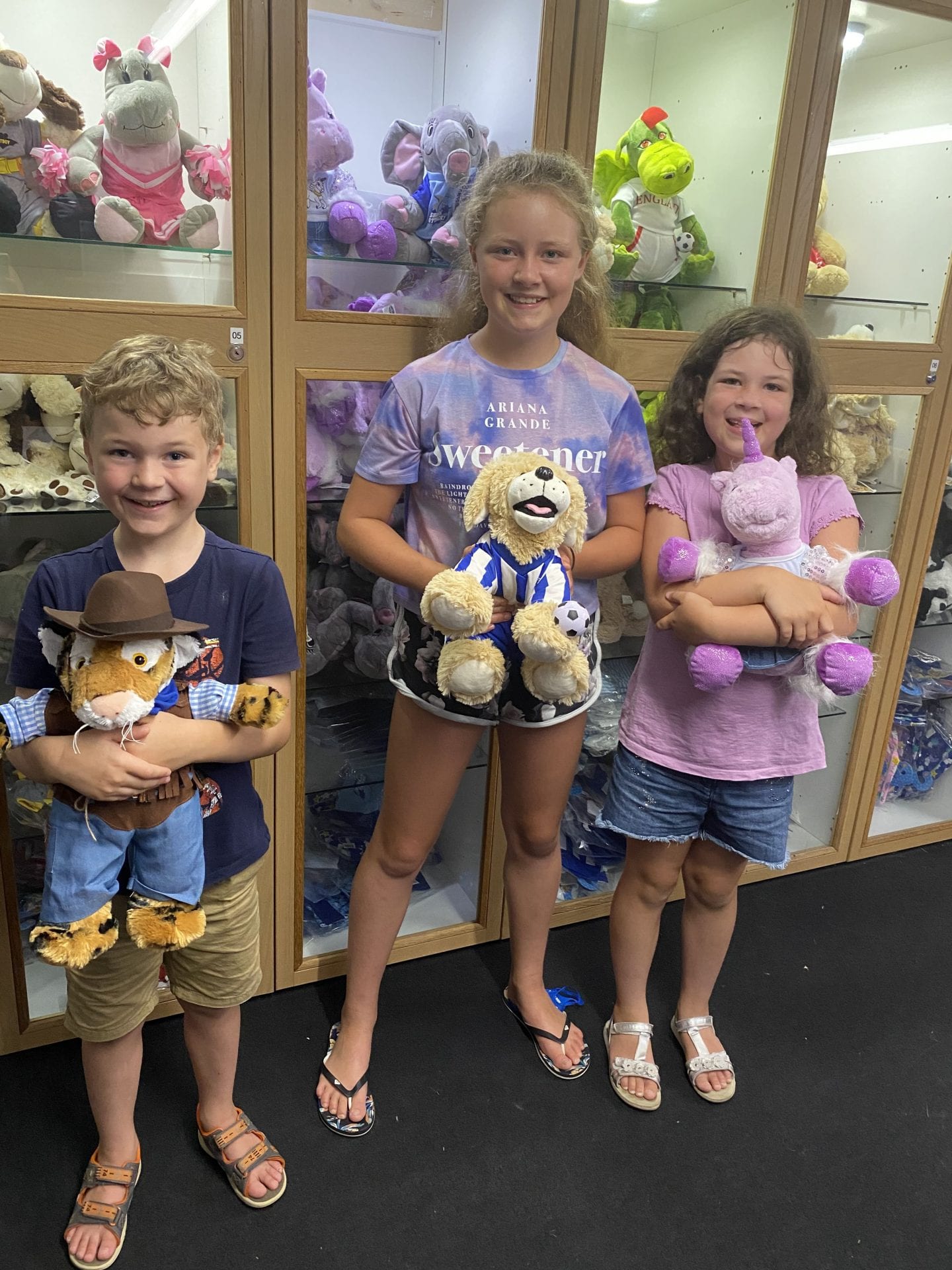 3 children holding the teddies that they had just made