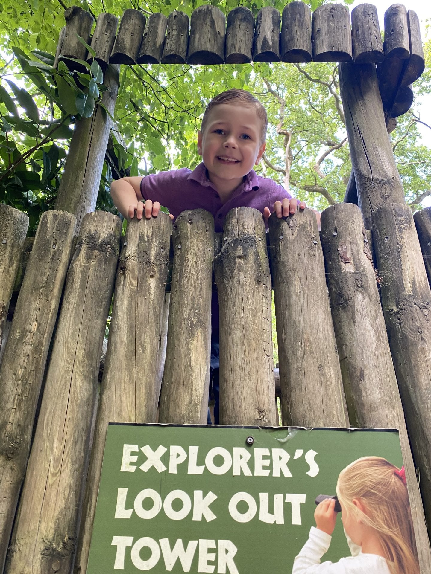 boy in a wooden look out tower