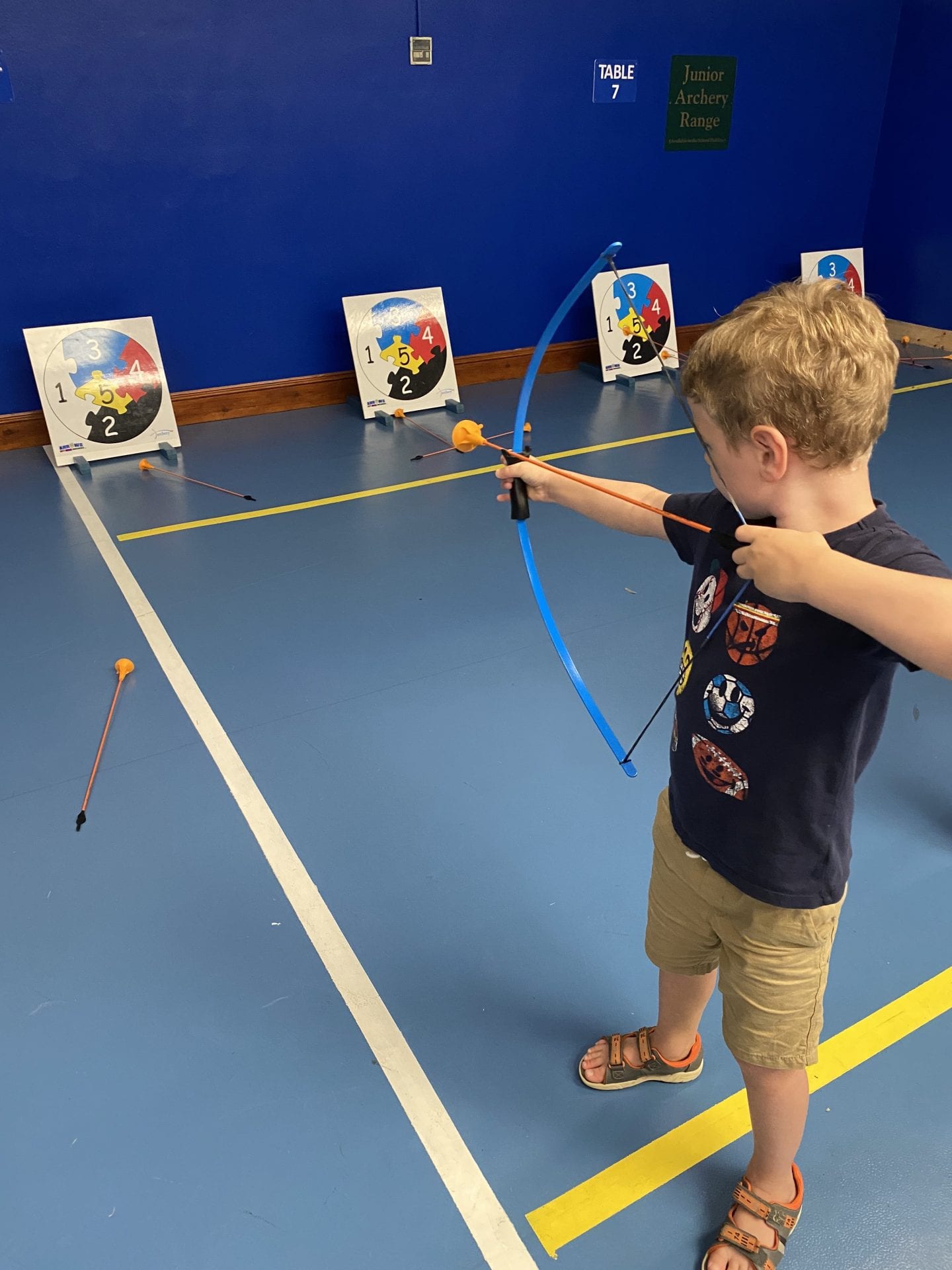 A boy doing junior archery