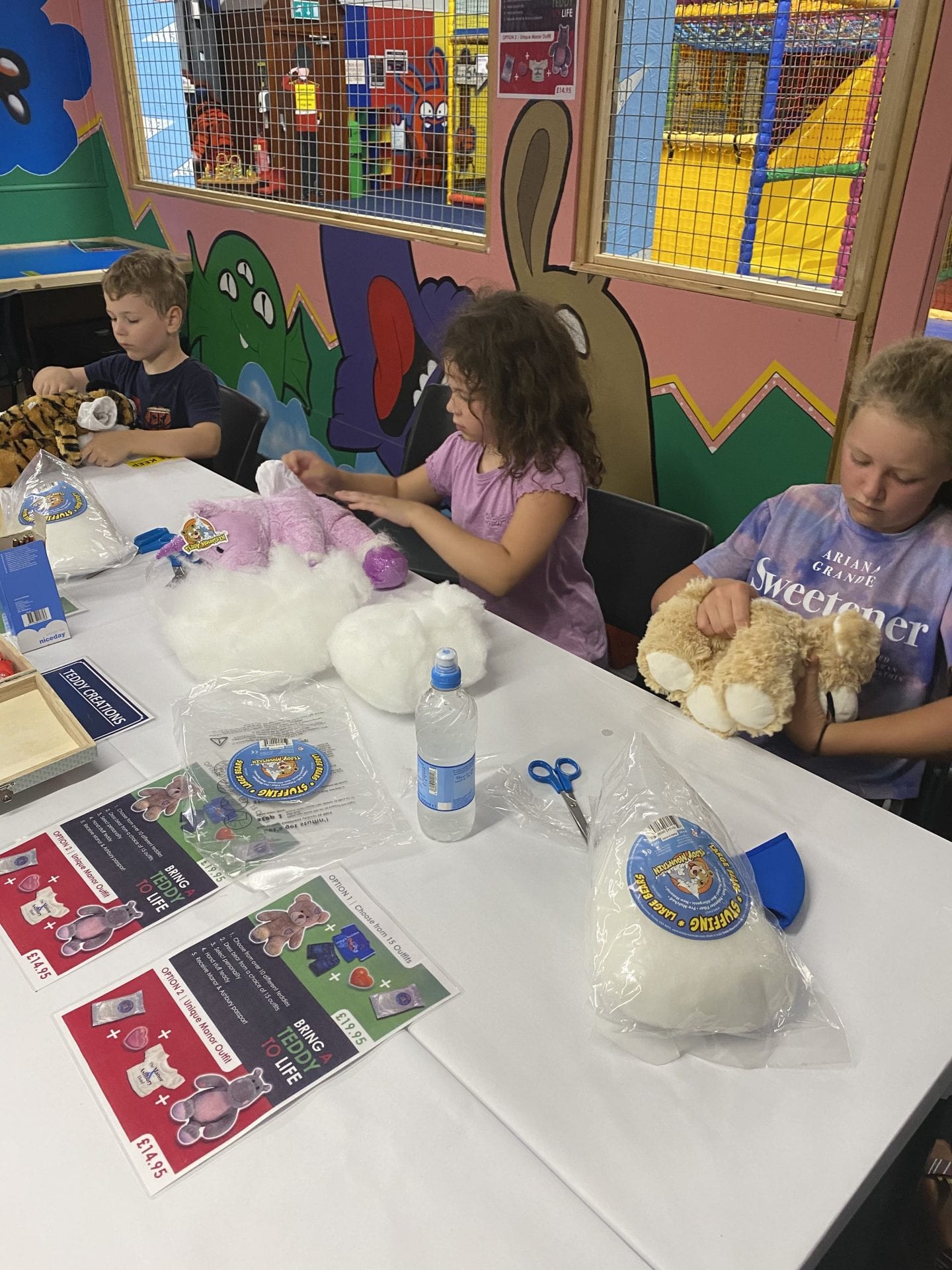 3 children making their own teddy bears