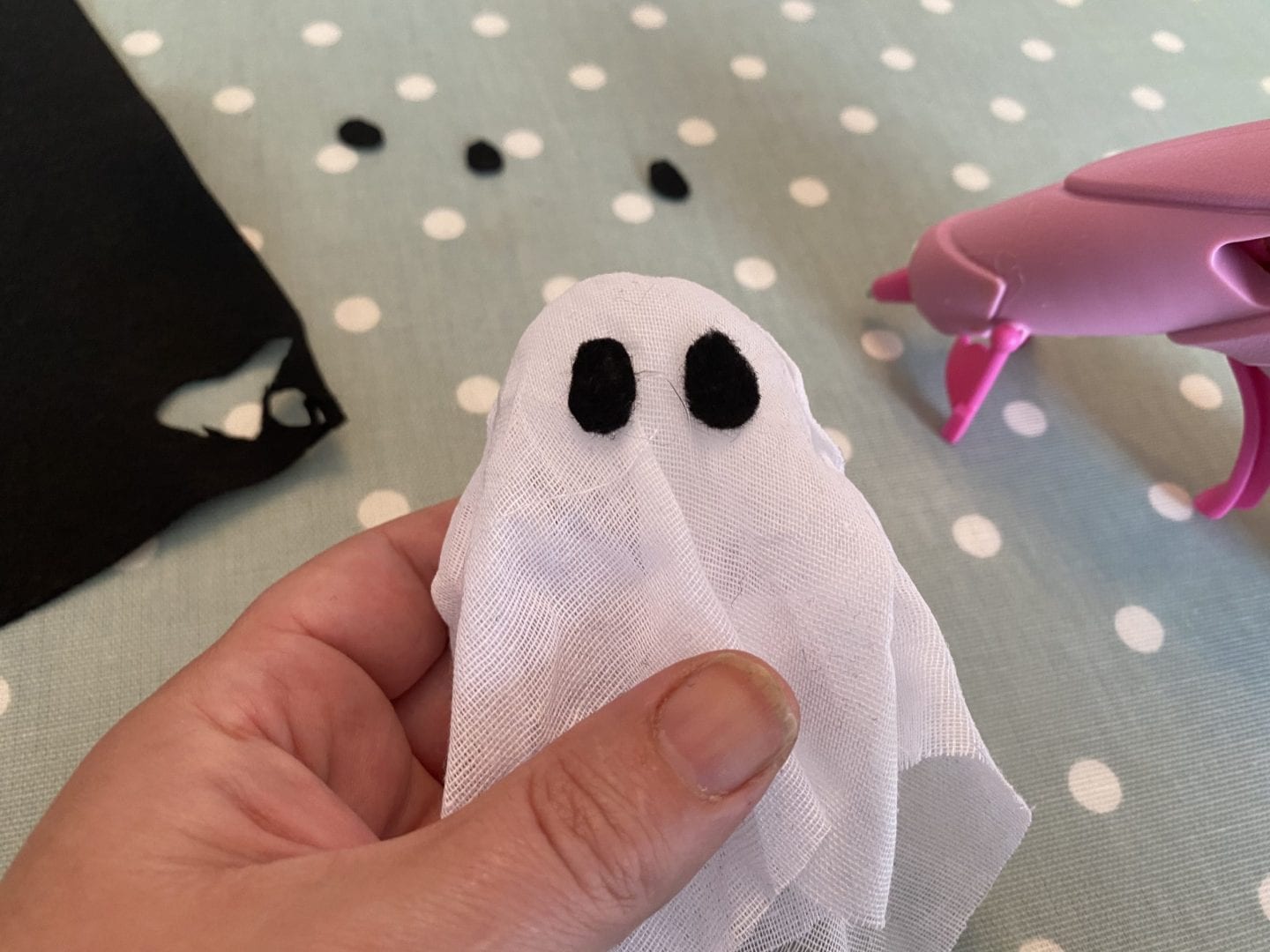 A muslin 'ghost' with two felt ovals stuck on for eyes