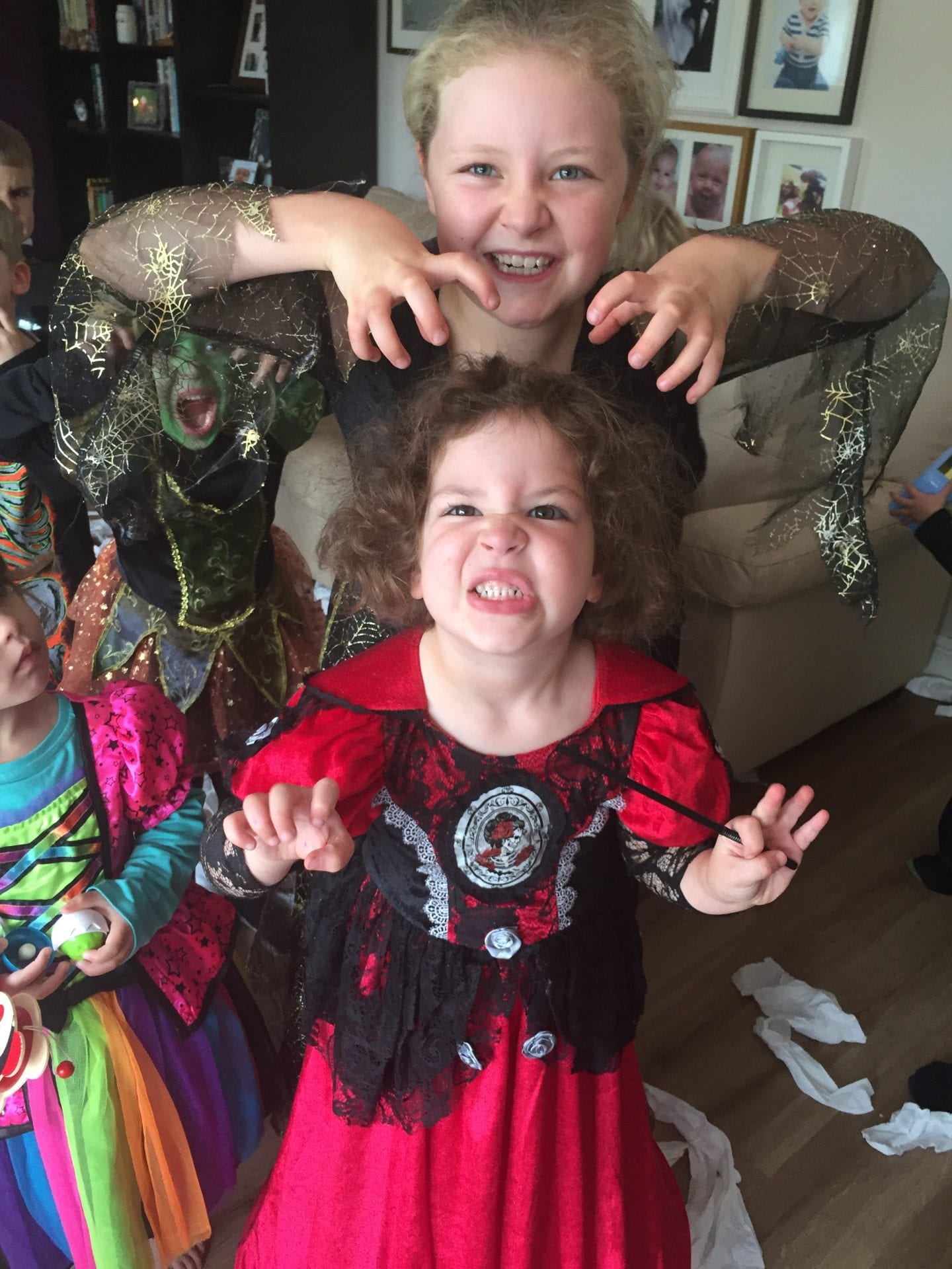 2 young girls dressed in Halloween costums making scary faces