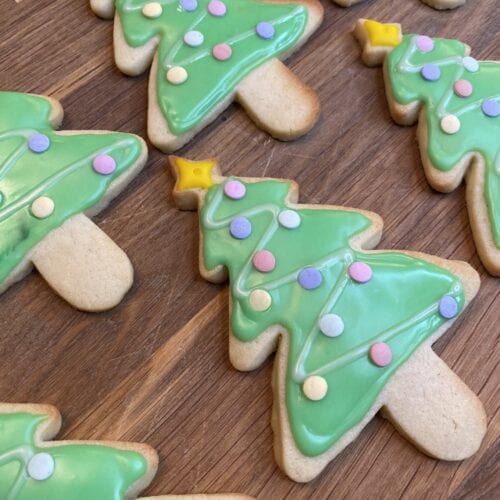 Several iced and decorated Christmas tree cookies