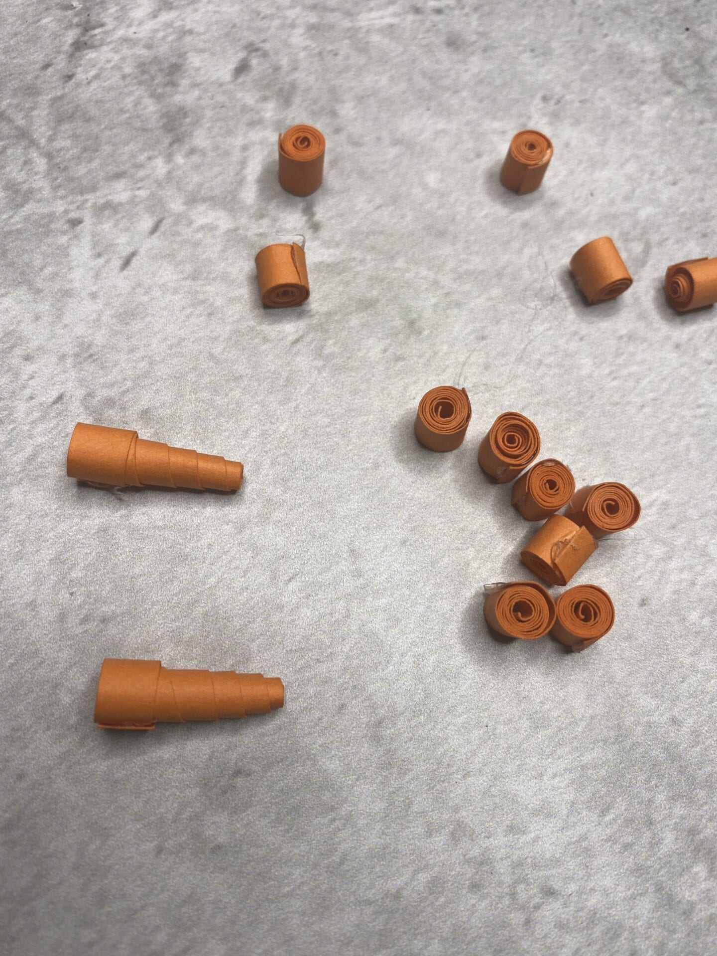 Strips of orange card rolled up and then the middle pushed out to make a 'carrot' nose