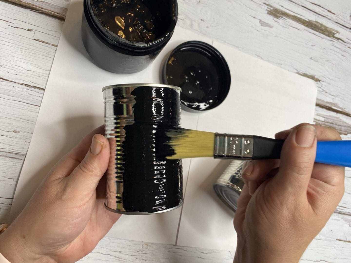 painting a tin can with blackboard paint