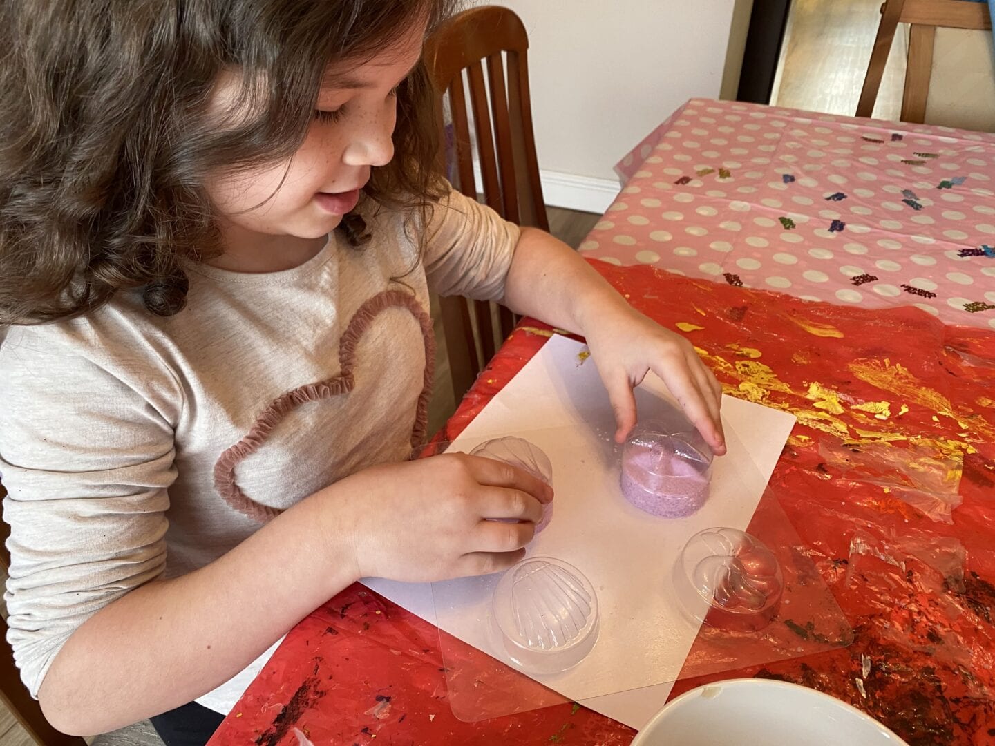 a young girl making bath bombs